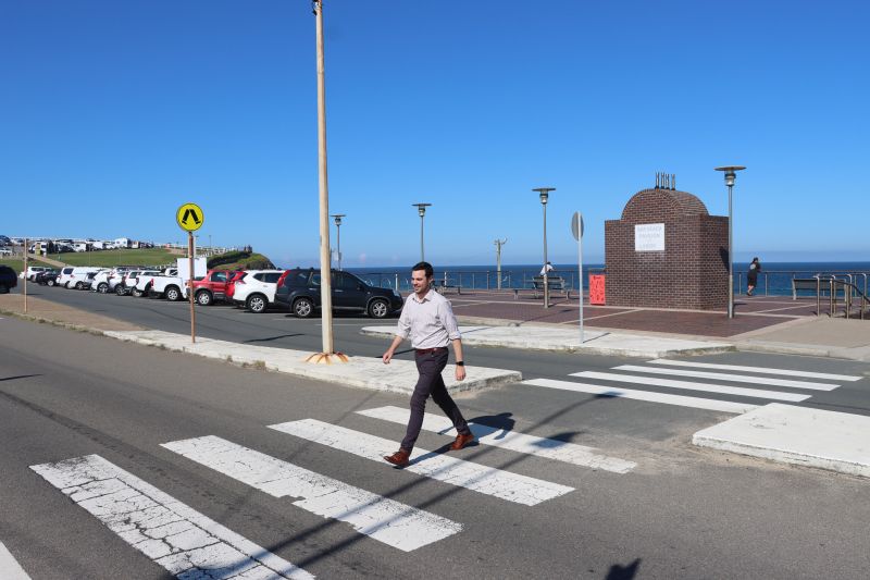 Deputy Lord Mayor Declan Clausen navigates Memorial Drive at the current pedestrian crossing, which will be upgraded to provide safer, easier connectivity in this busy coastal precinct.