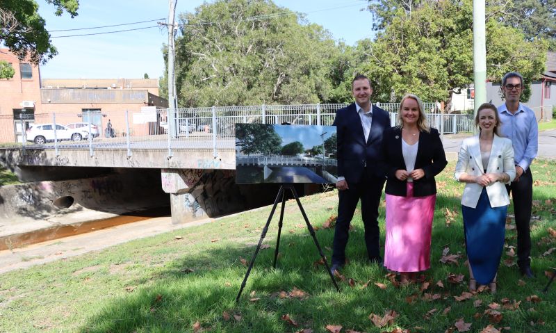 Councillor Callum Pull, Lord Mayor Nuatali Nelmes, Councillor Elizabeth Adamczyk and former Councillor Jason Dunn with one of the artist's impressions of the new Boscawen Street Bridge, which is being replaced as part of flood mitigation works in Wallsend.