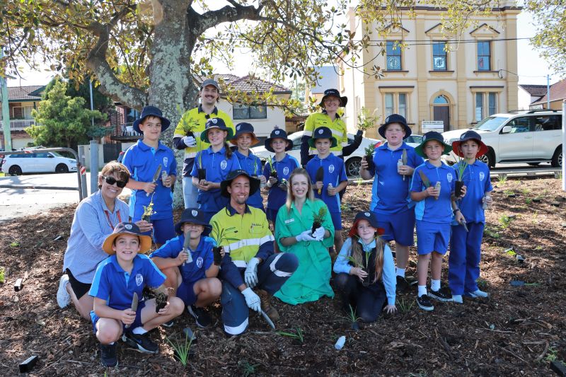 Cr Elizabeth Adamczyk (middle) with City of Newcastle staff, Year 4 teacher Therese Jackman and students from St Therese's Primary School, who took part in the outdoor classroom event at Lambton Park today.