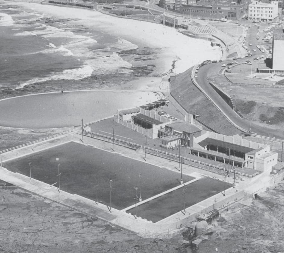 A historical aerial photograph of Newcastle Ocean Baths and Newcastle Beach.