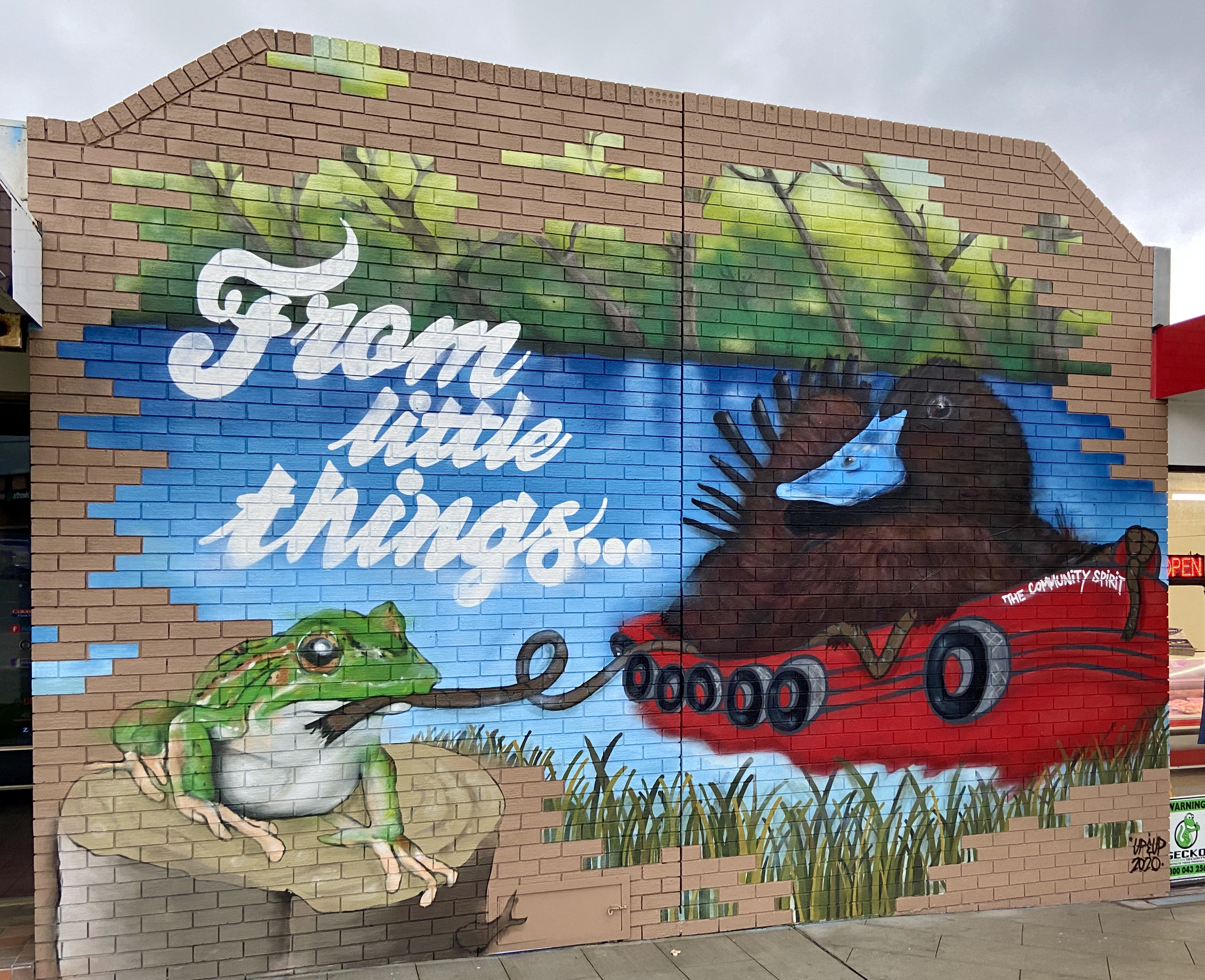 Image of mural on wall featuring a duck and a frog under the words From Little Things