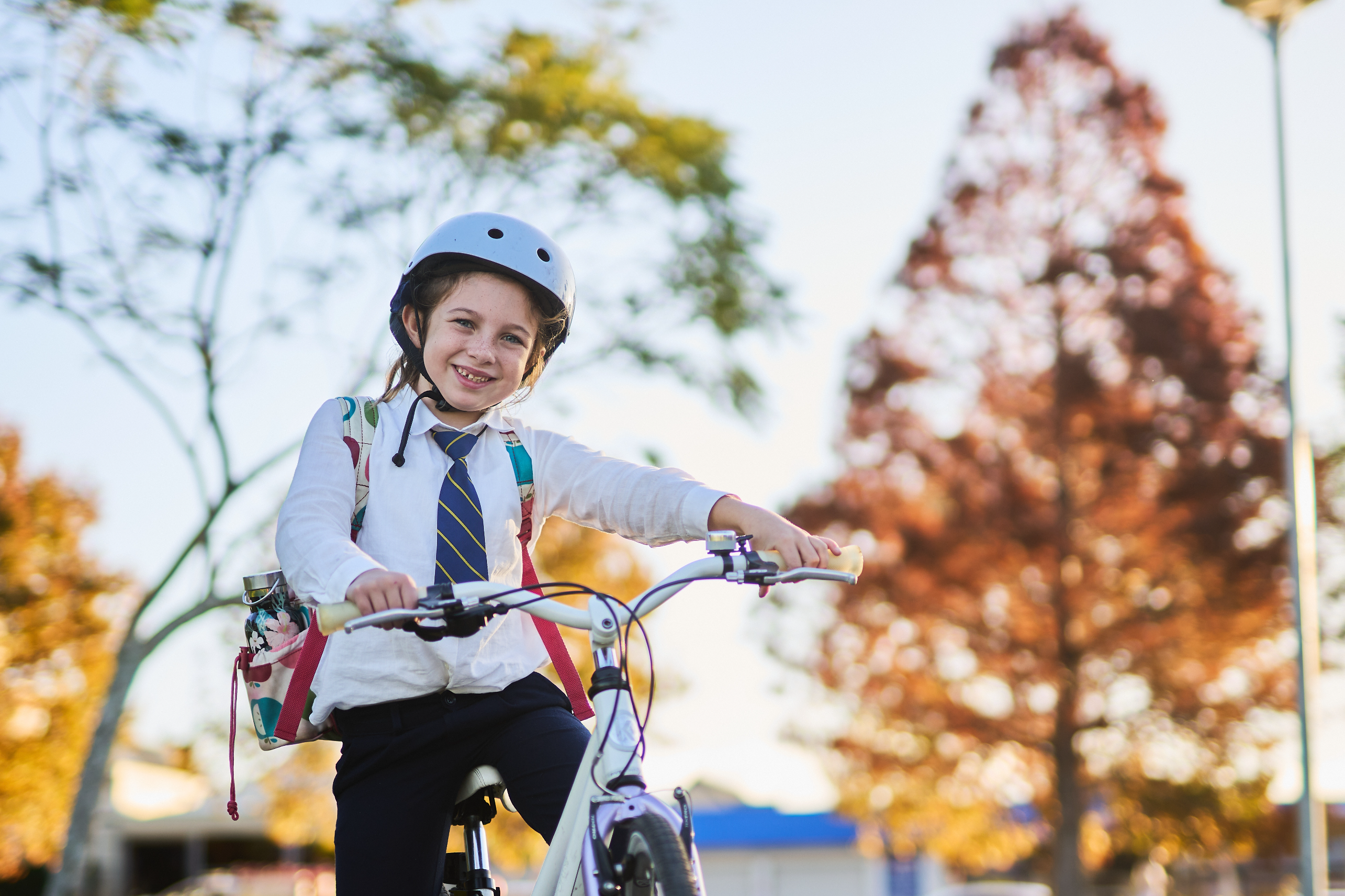 primary school aged girl riding a bike to school