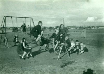 Several children on a seesaw at Islington Park