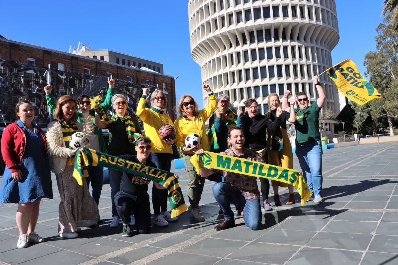 Newcastle Deputy Lord Mayor Declan Clausen and Councillors Peta Winney-Baartz, Deannha Richardson and Elizabeth Adamczyk with former Mataildas players, members of the Newcastle-based Matildas Active Support group and a representative from the Newcastle BIA celebrate the announcement of live outdoor screenings of Australia's matches during the FIFA Women's World Cup this month.