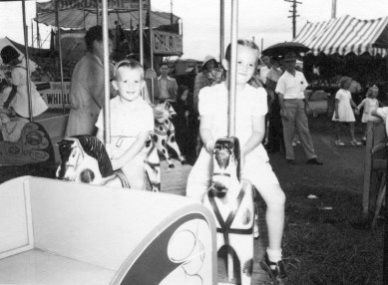 Children riding merry-go-round horses at the Newcastle Show